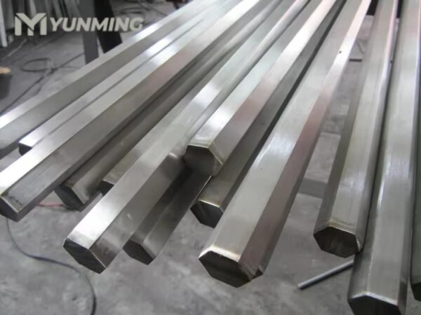 Hexagonal stainless steel bars arranged on factory floor
