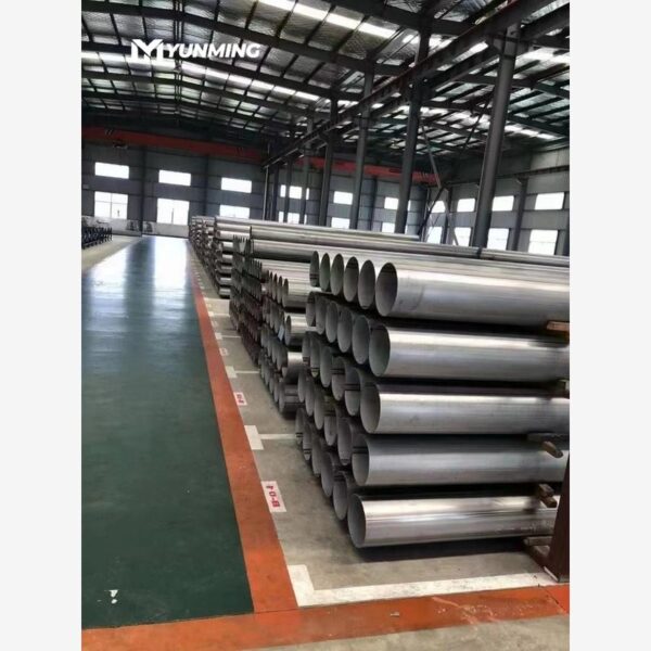 Stainless steel industrial pipes stacked in factory inventory area